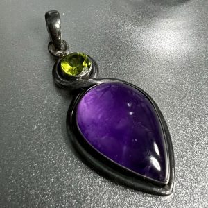 Large amber and peridot pendant encased in silver