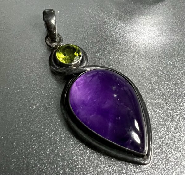 Large amber and peridot pendant encased in silver