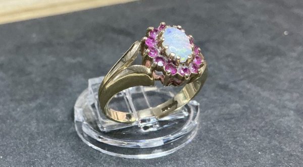 9 carat gold opal and red ruby halo ring