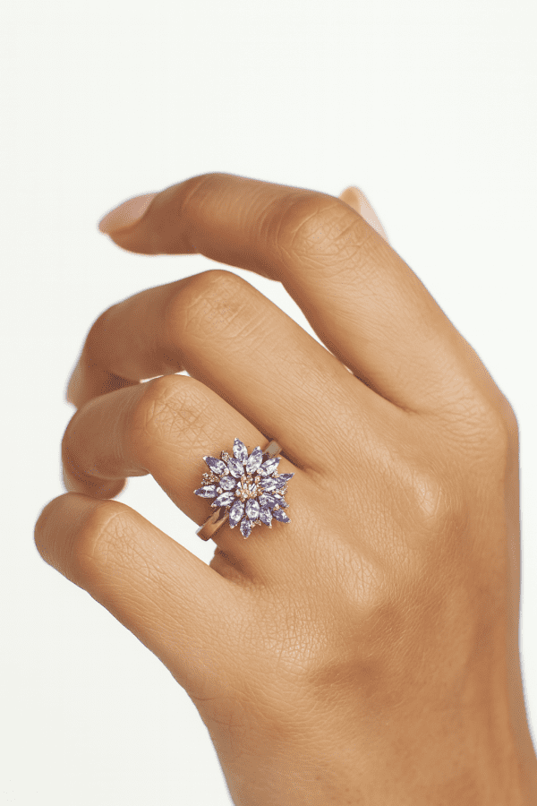 A striking sterling silver ring featuring a vivid cluster of marquise-cut tanzanite gemstones. The 2cm crown creates an unforgettable statement of elegance.